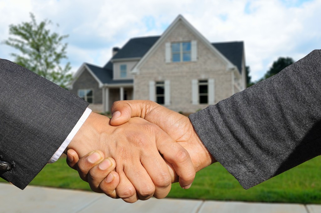 two men doing a handshake for a home sale